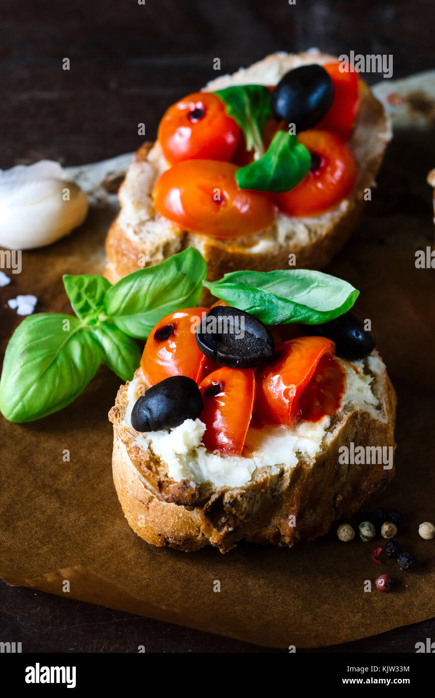 Traditional Italian bruschettas with grilled tomato on wooden background,selective focus Stock Photo