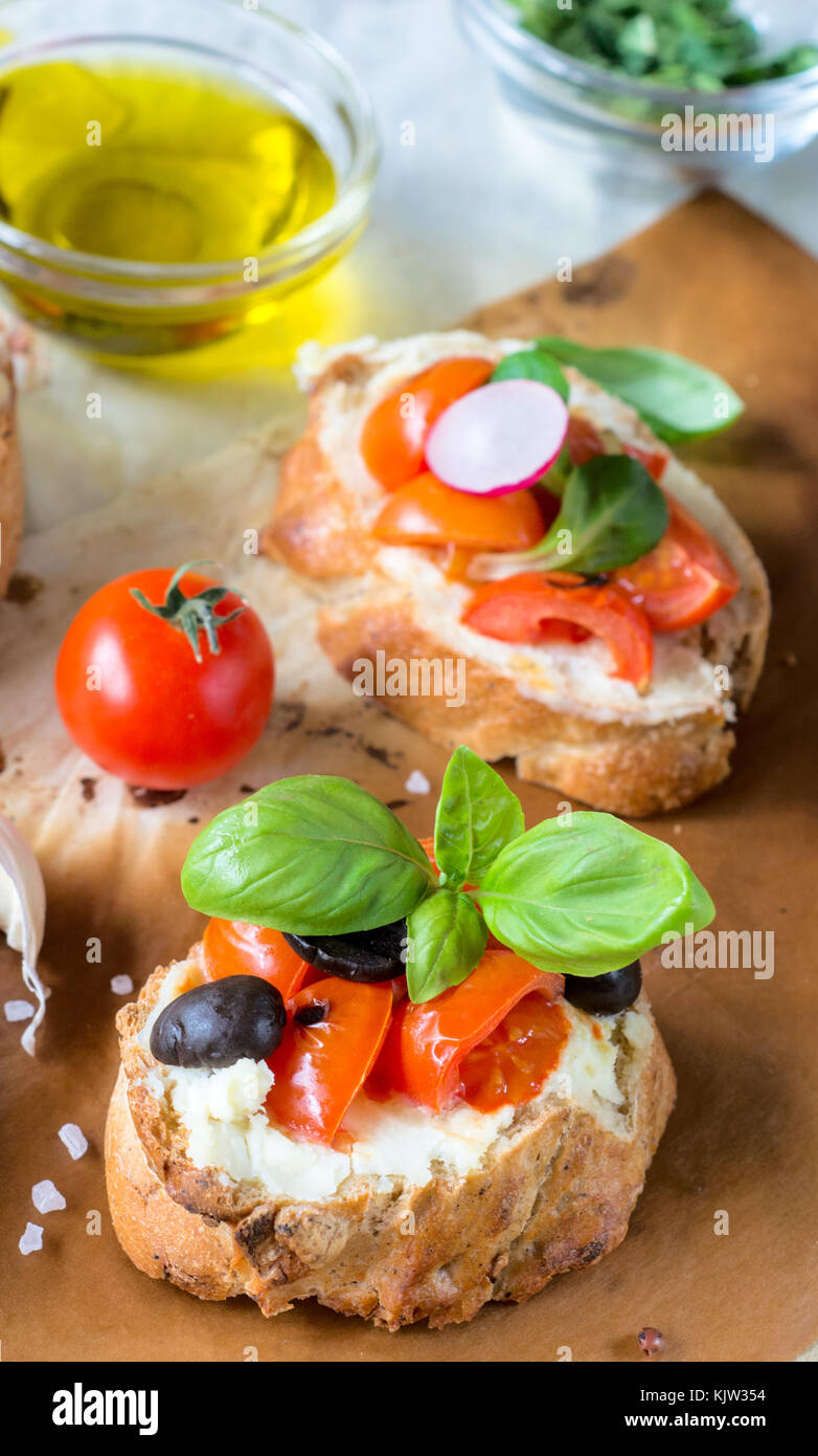 Vegetarian bruschettas with grilled cherry tomato and cream cheese,selective focus Stock Photo