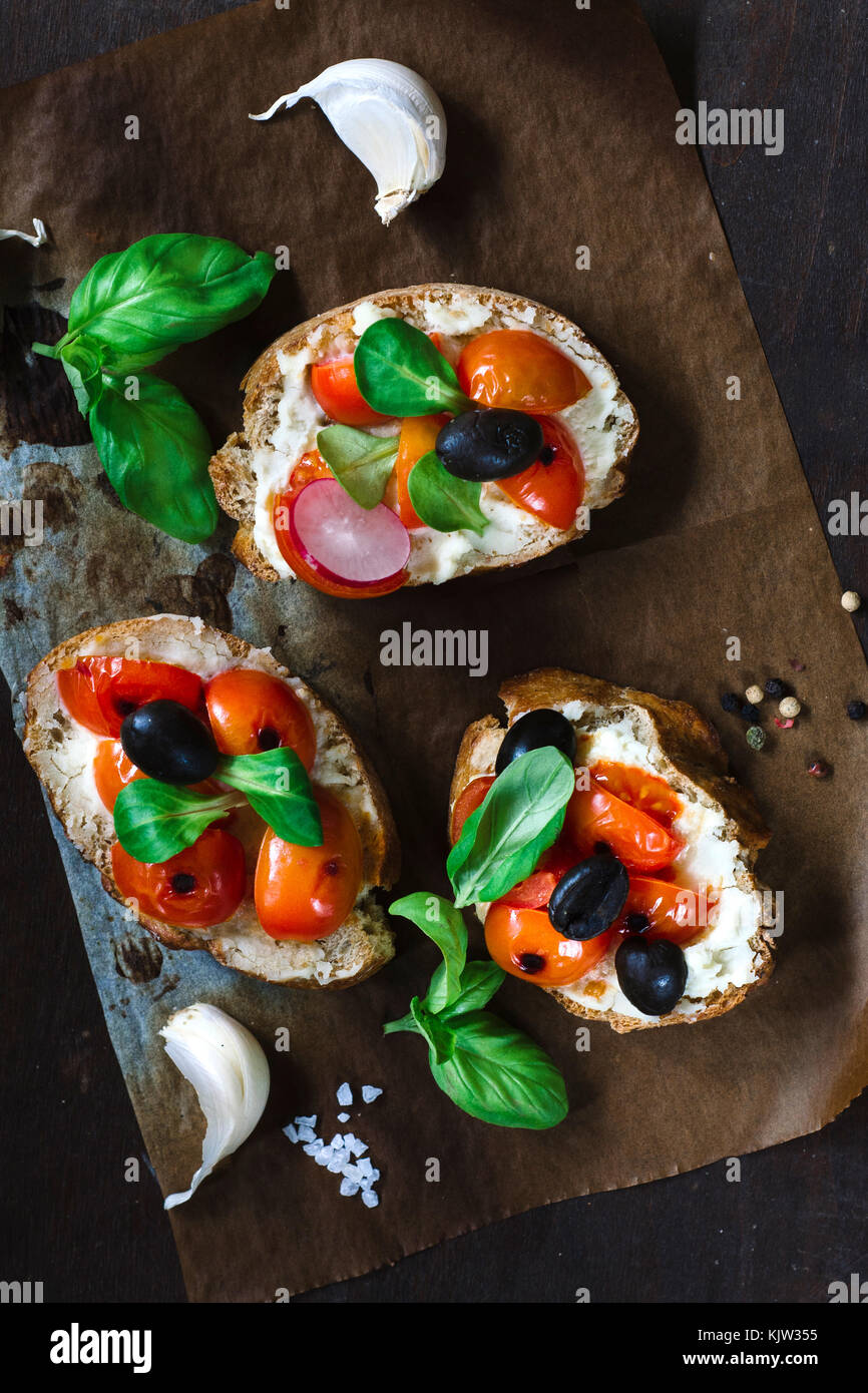 Vegetarian Italian bruschettas with grilled tomato and cream cheese from above,selective focus Stock Photo