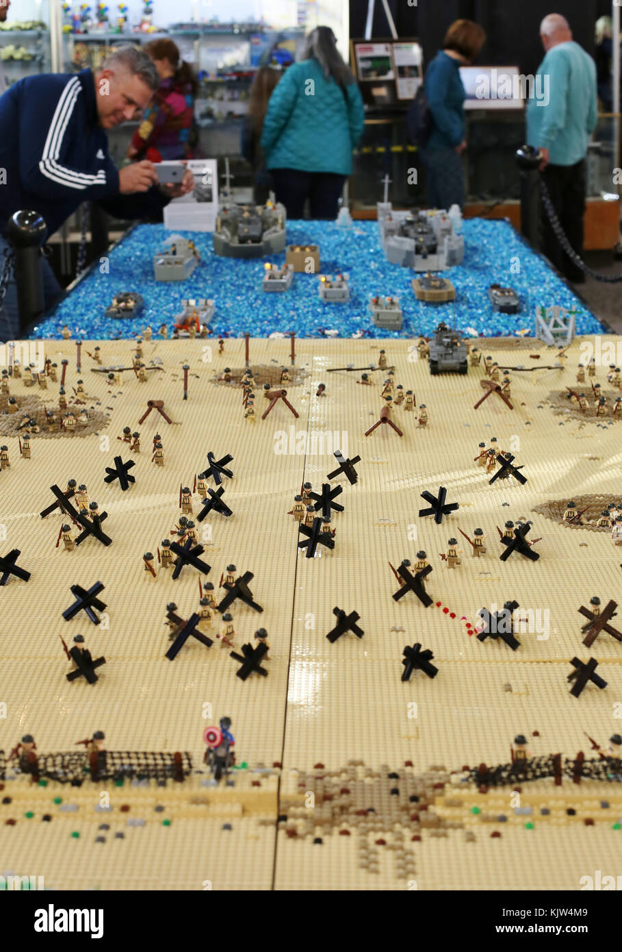 Minneapolis, Minnesota, USA. 25th November, 2017. A man takes a picture of  the invasion at Omaha Beach, recreated entirely of LEGO bricks, on display  at the LEGO Fan Expo in Minneapolis, Minnesota.