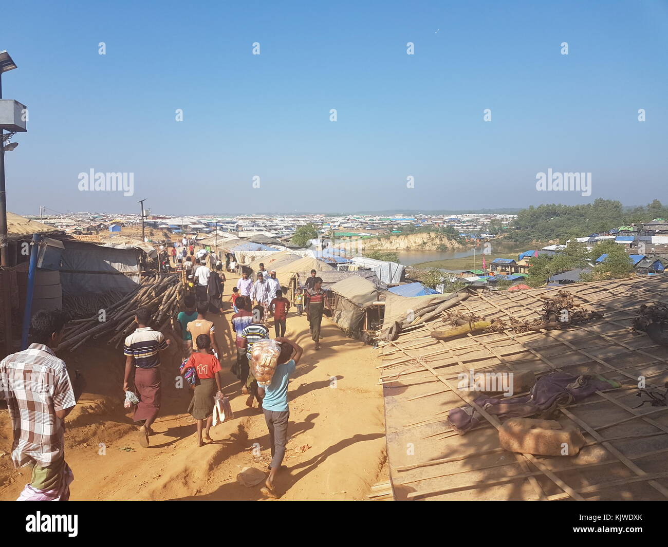 Rohingya refugees walks across the refugee camp Kutupalong, Bangladesh, 26 November 2017. A majority of the more than 620.000 members of the Muslim minority, who fled from the military in their home country Myanmar, lives here since end of August. Photo: Nick Kaiser/dpa Stock Photo