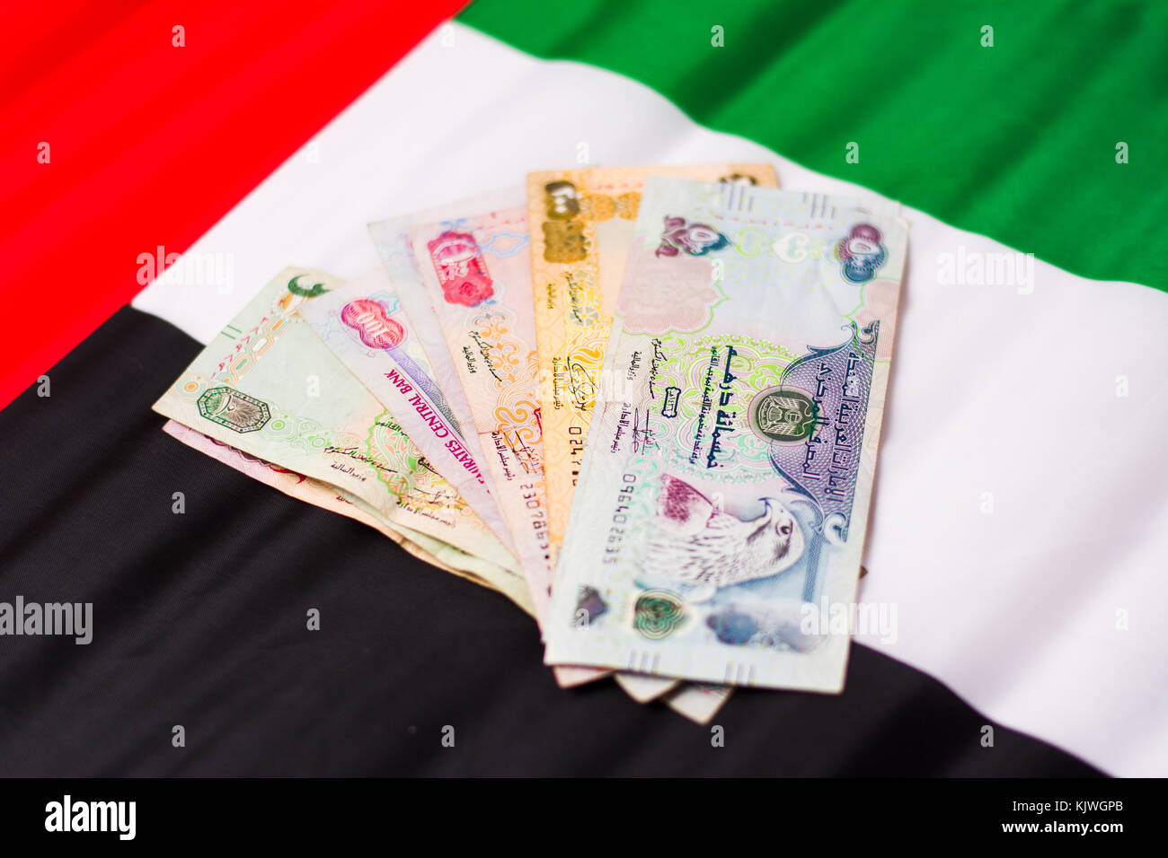 United Arab Emirates dirham banknotes on top of flag Stock Photo