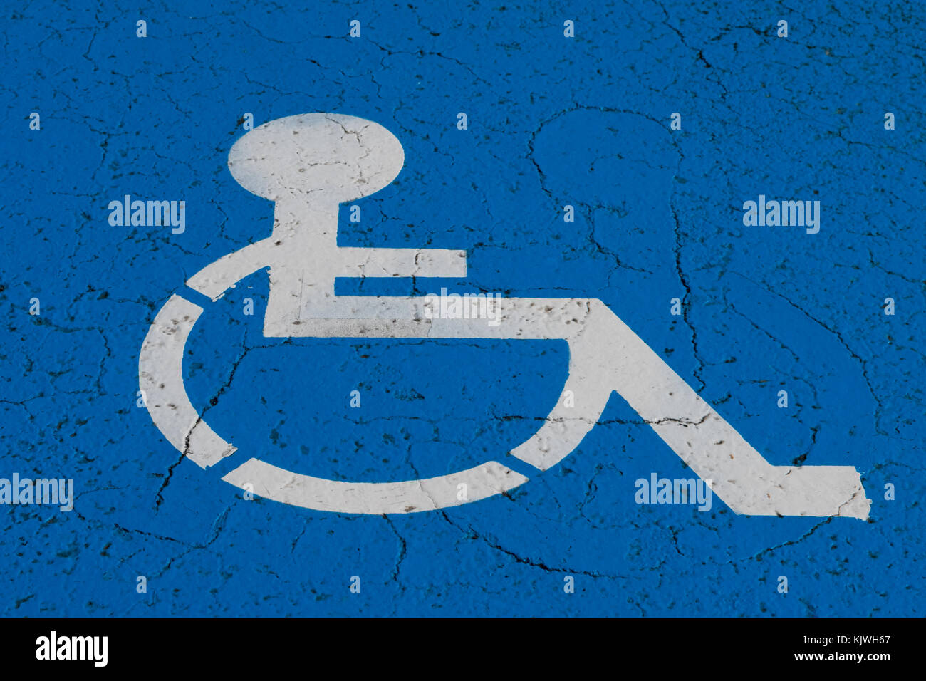 wheelchair symbol on handicap parking spot - Stock Photo