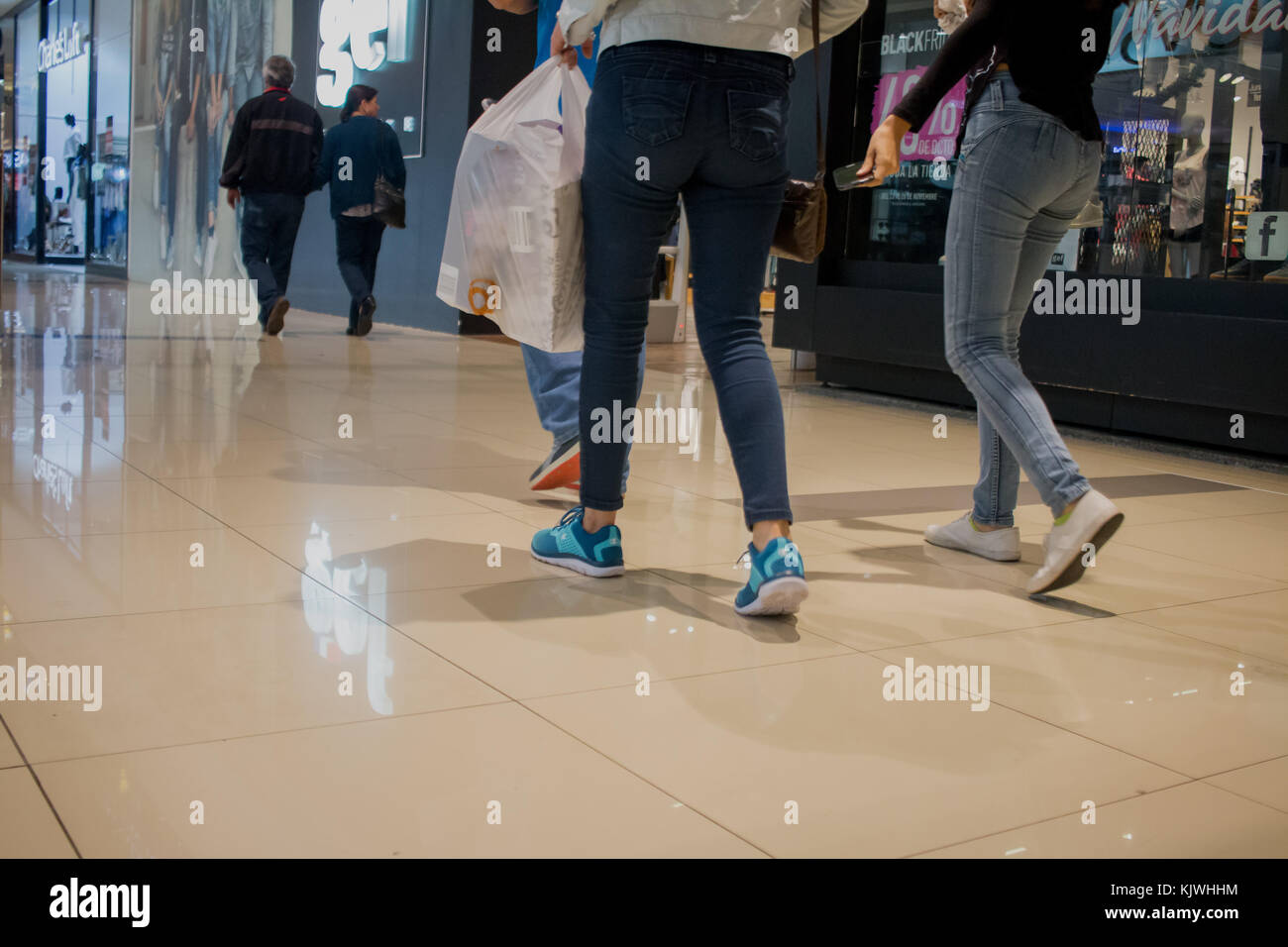 People walking through mall with shopping bags. Personas en centro comercial, bolsas de compras. photo by: Roberto Carlos Sánchez @rosanchezphoto Stock Photo