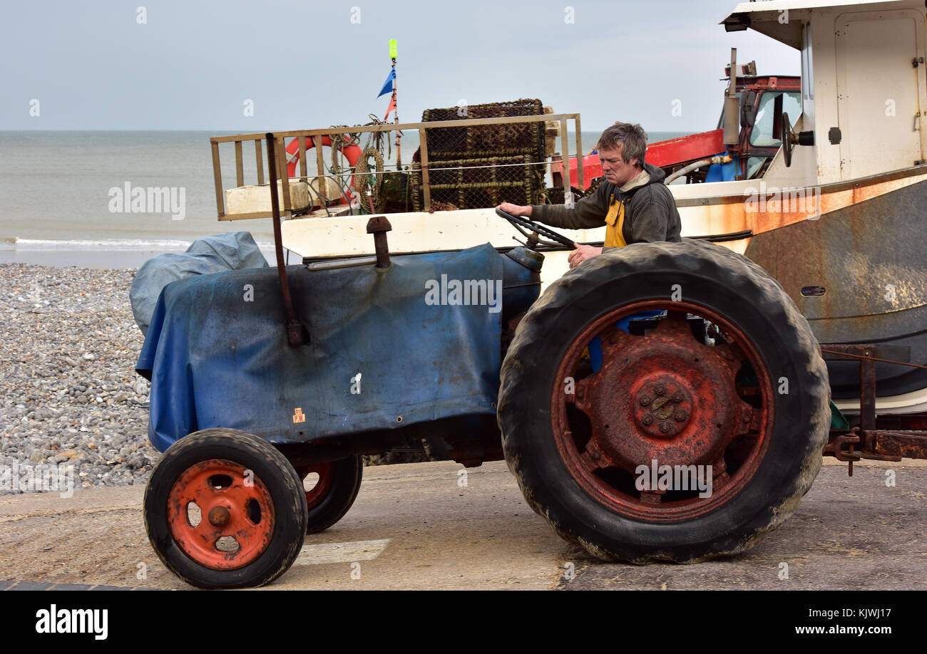A crab fisherman in Cromer in Norfolk launching his fishing boat by