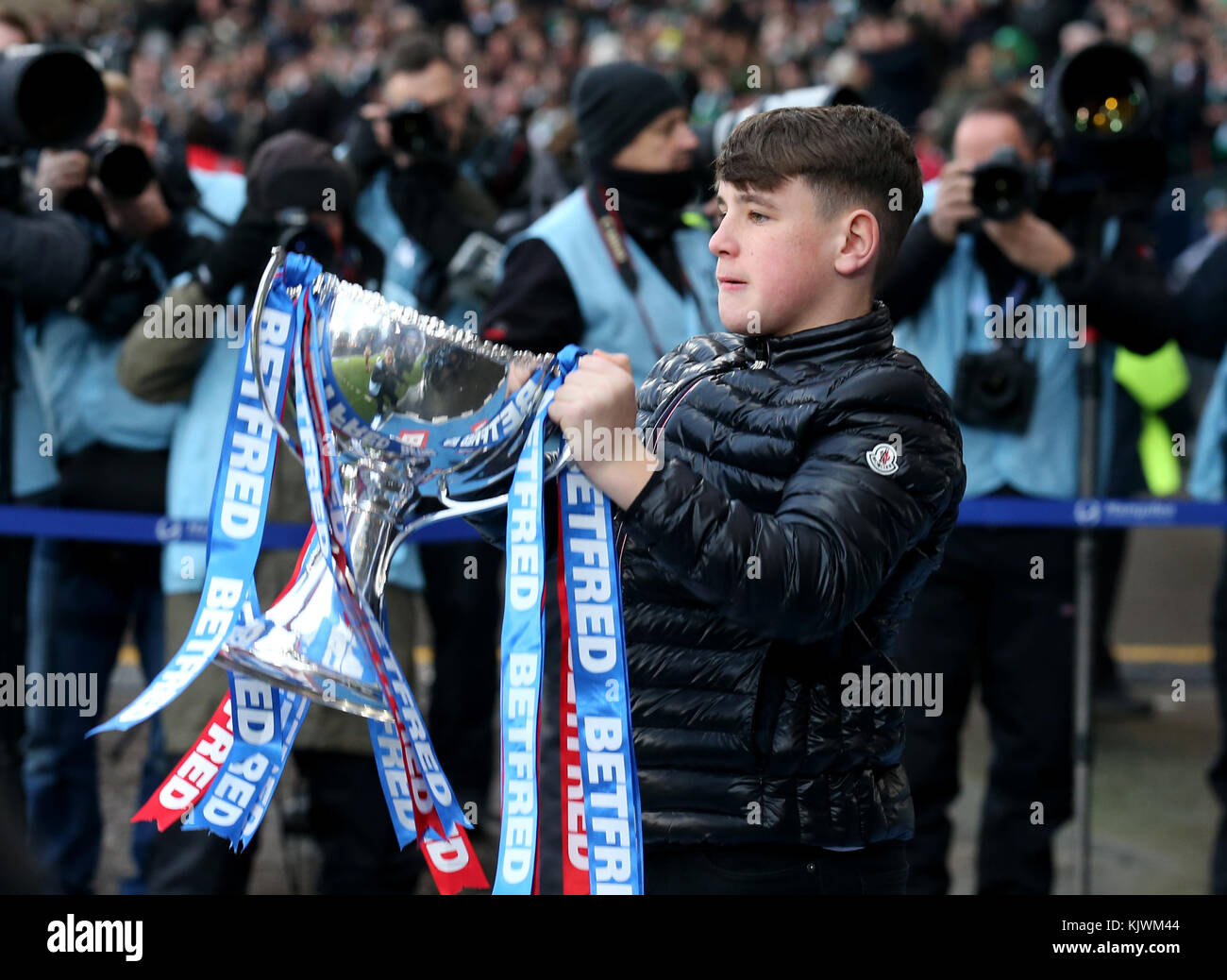 Former Motherwell player Phil O'Donnell's son carries the trophy out