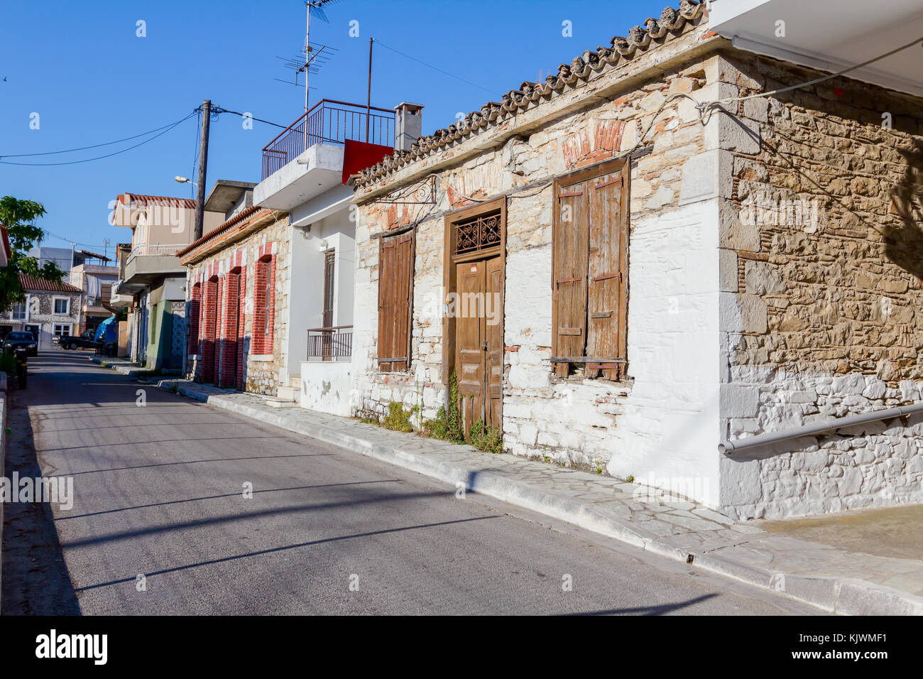 Ancient stone house with closed rustic brown wooden window shutters ...