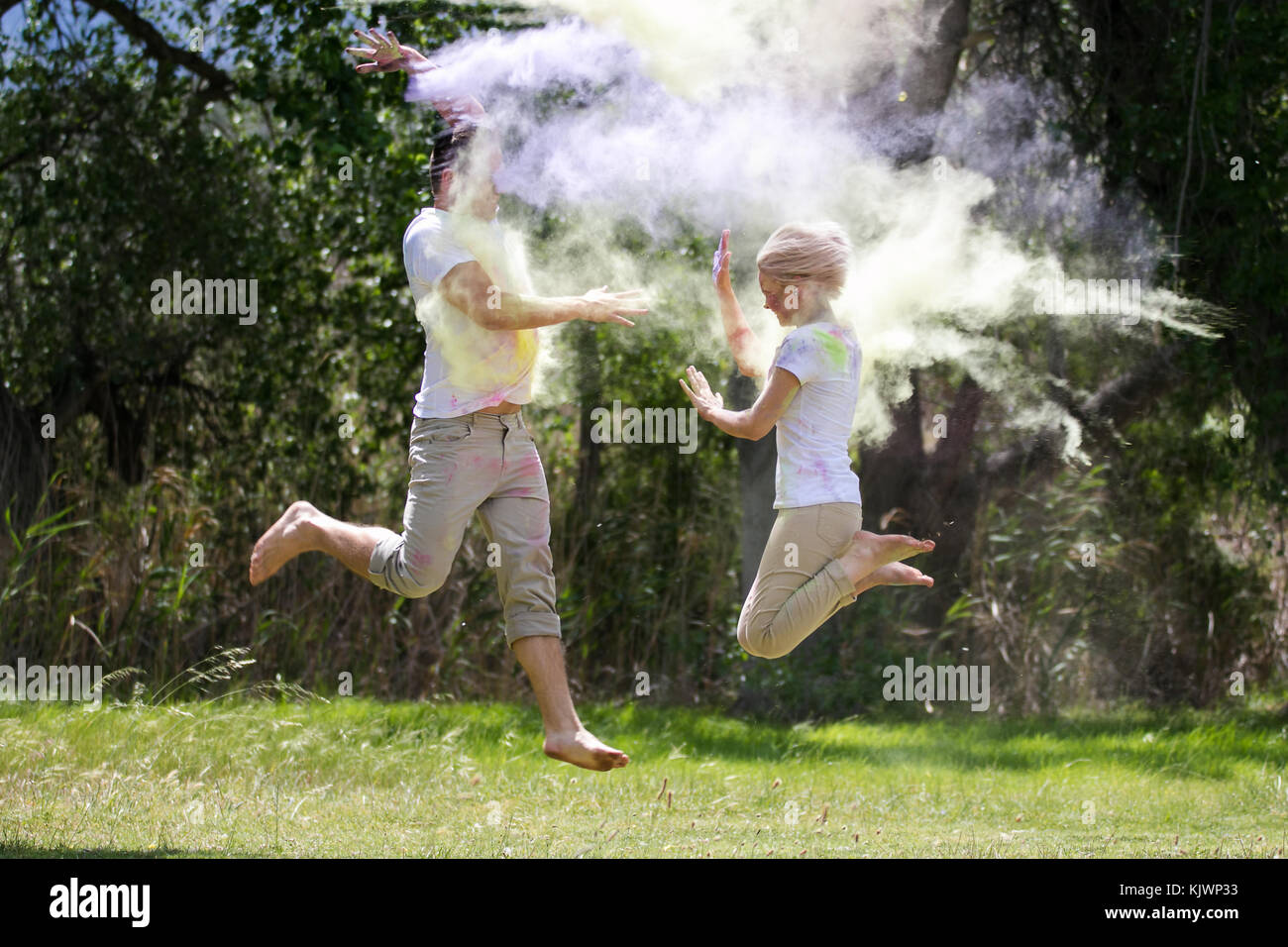 Powder Paint Playing Young funky couple playing with colorful water paint powder on the Holi ...