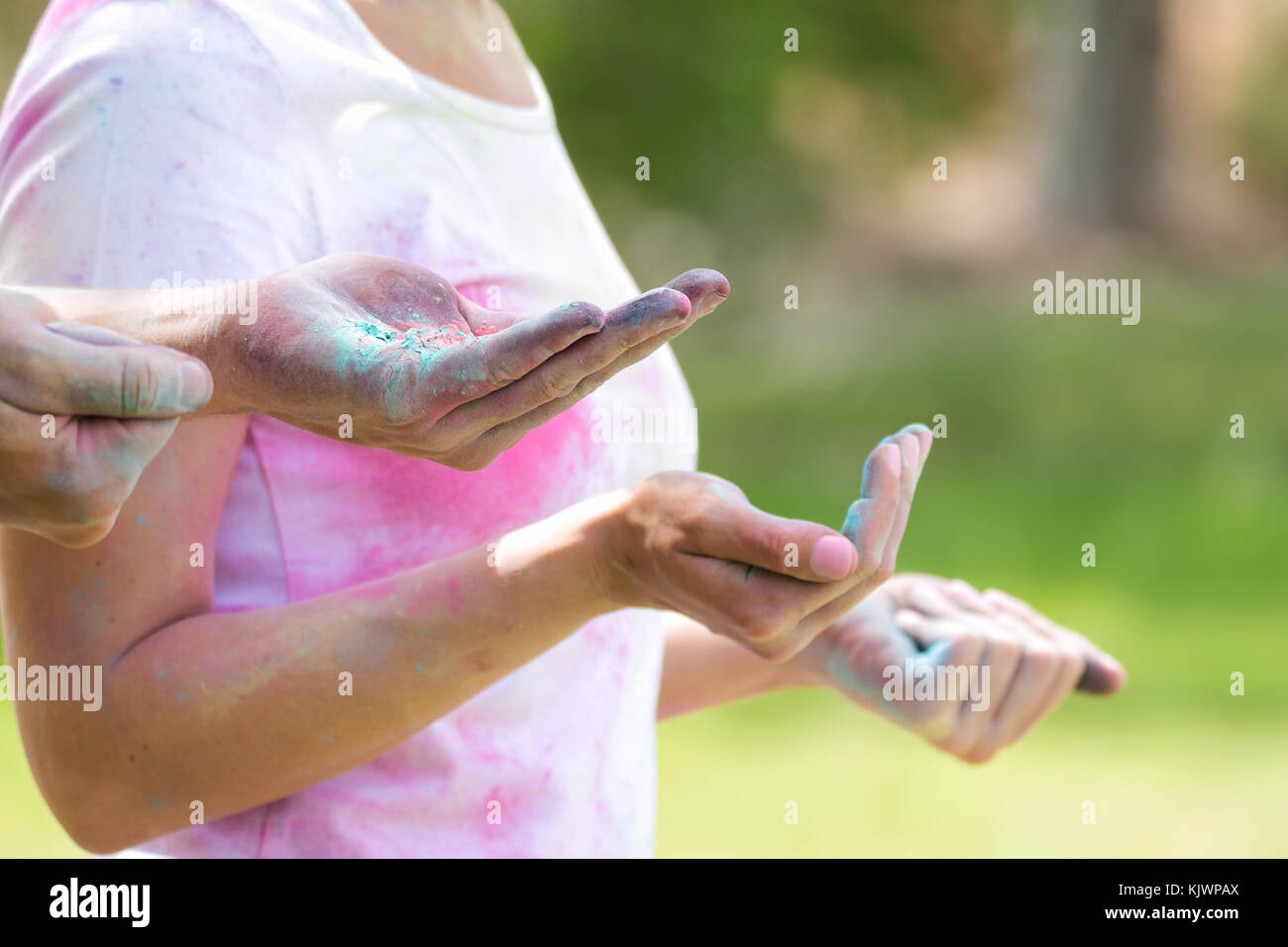 Powder Paint Playing Young funky couple playing with colorful water paint powder on the Holi ...