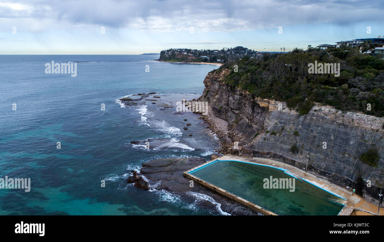 Aerial view of seaside ocean swimming pool set against rock cliffs at Bilgola Beach, Sydney Australia Stock Photo