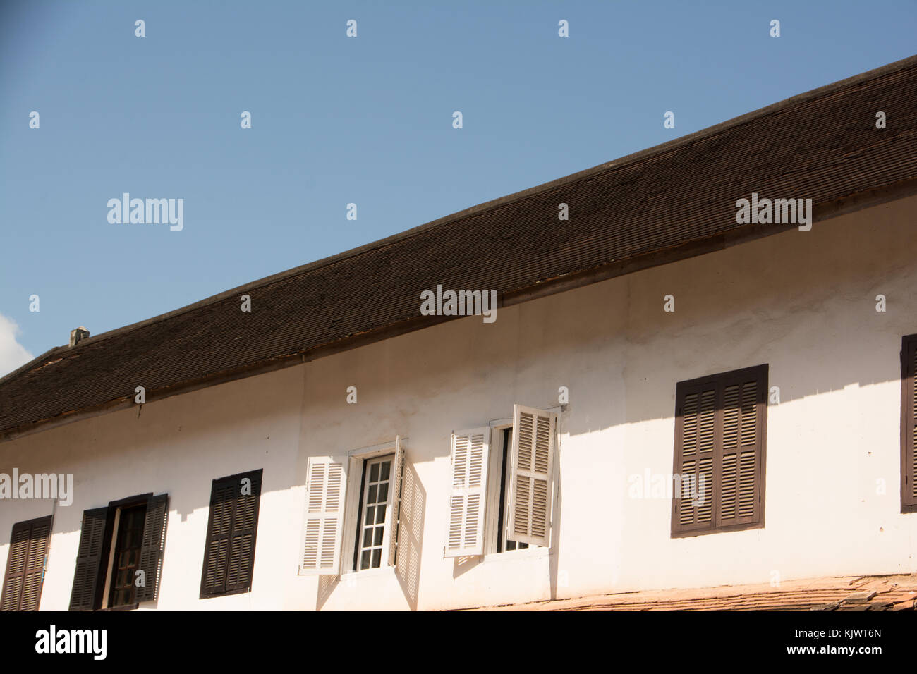 open windows of an old colonial building in Laos Stock Photo