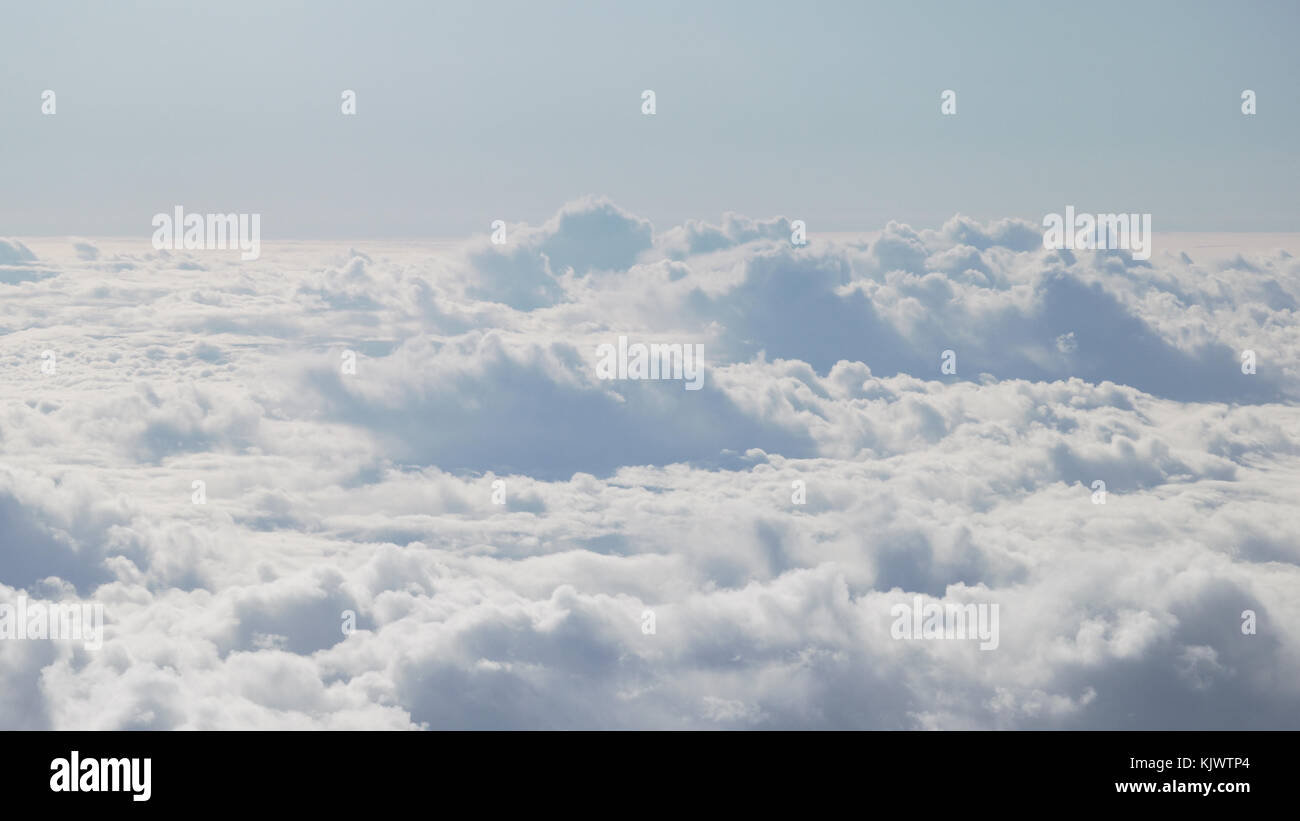 aerial shot from plane flying above the clouds in daytime Stock Photo ...