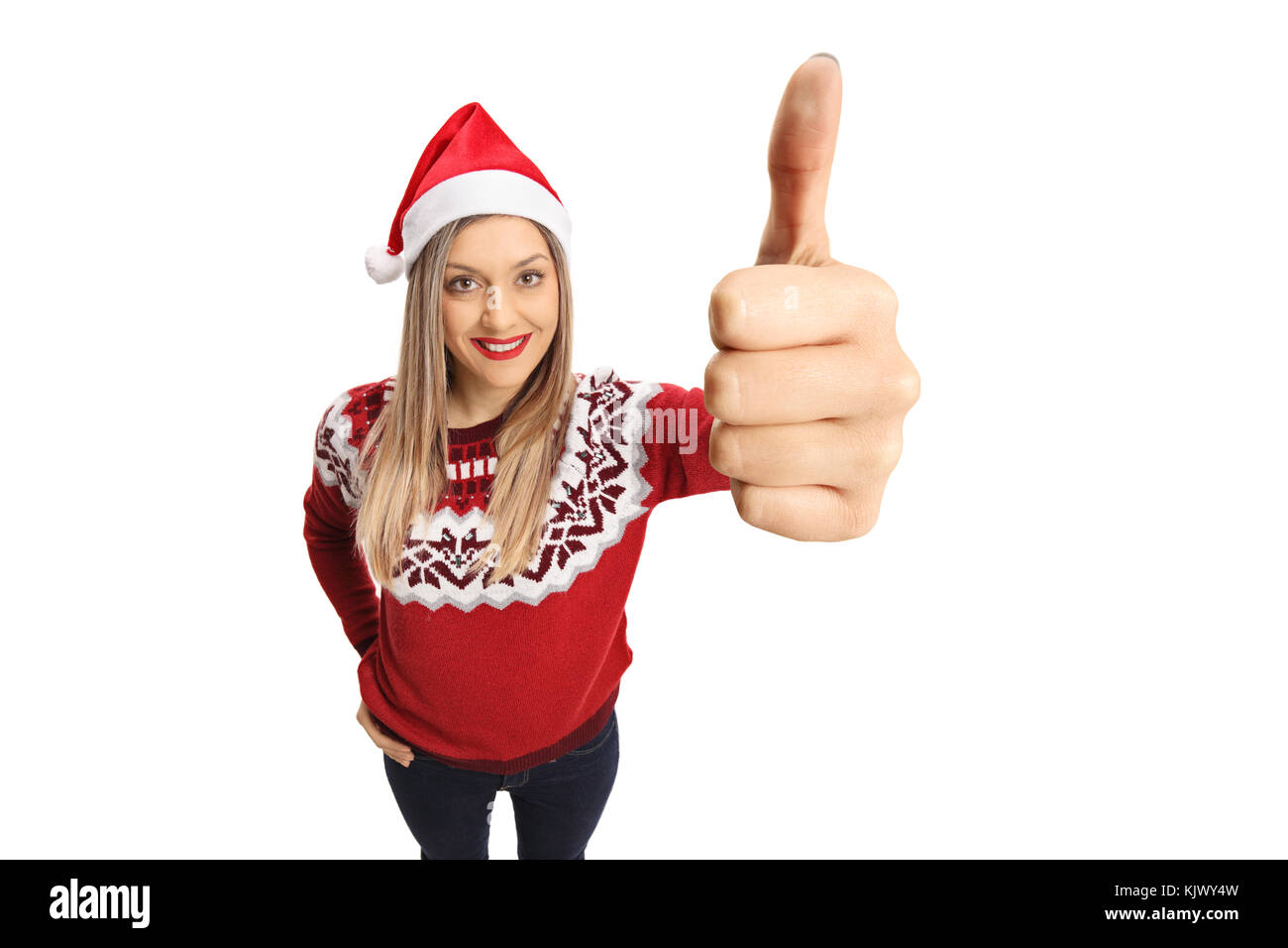 Young woman with a christmas hat making a thumb up sign isolated on white background Stock Photo