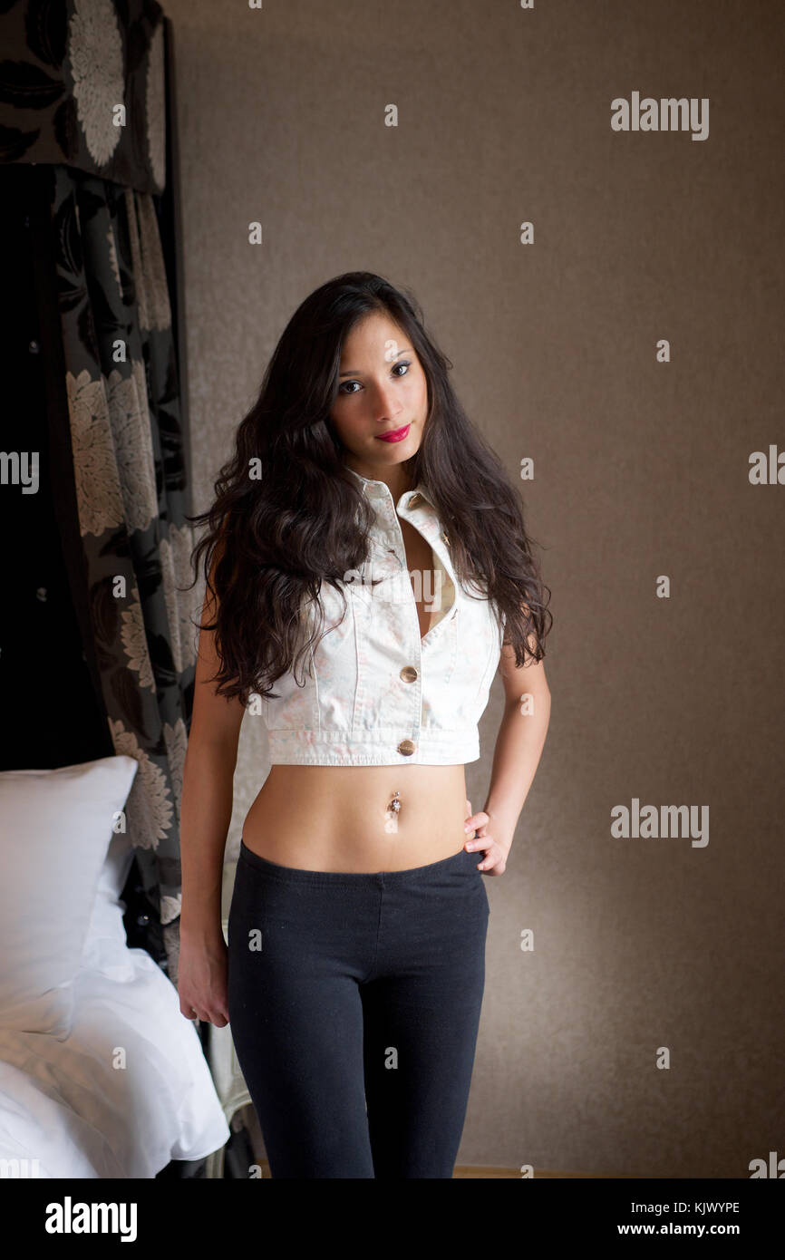 https://c8.alamy.com/comp/KJWYPE/beautiful-brunette-girl-wearing-black-leggings-in-a-bedroom-location-KJWYPE.jpg