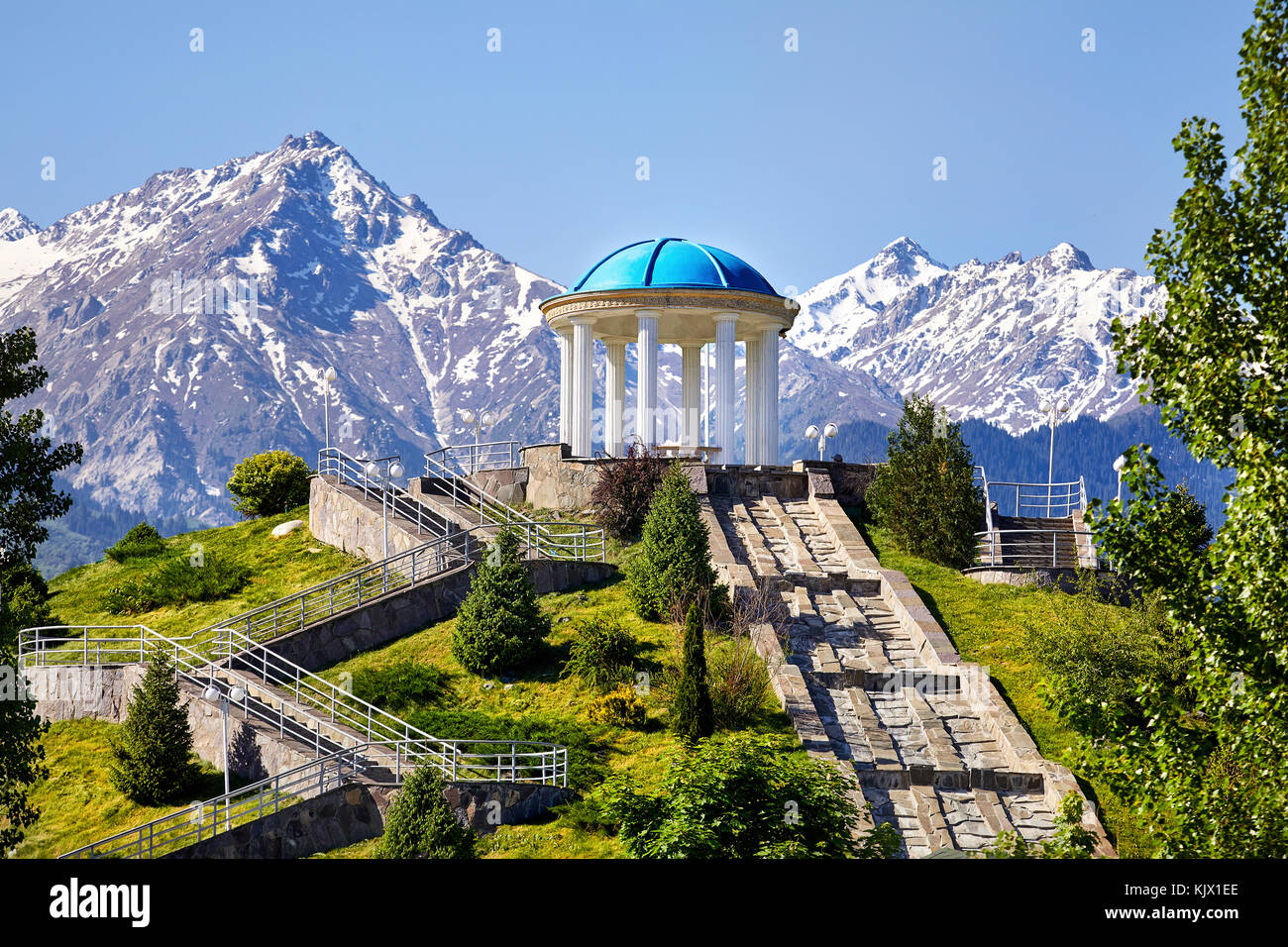 View to the monument with at snowy mountains background in dendra park of first president Nursultan Nazarbayev in Almaty, Kazakhstan Stock Photo