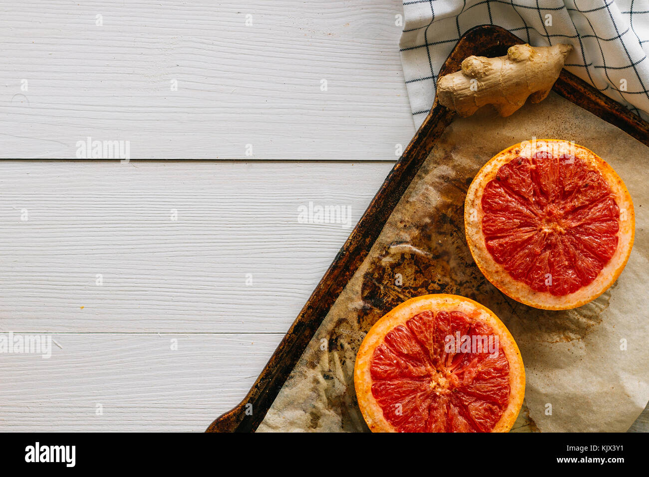 Baked grapefruit on metal pan top view selective focus Stock Photo