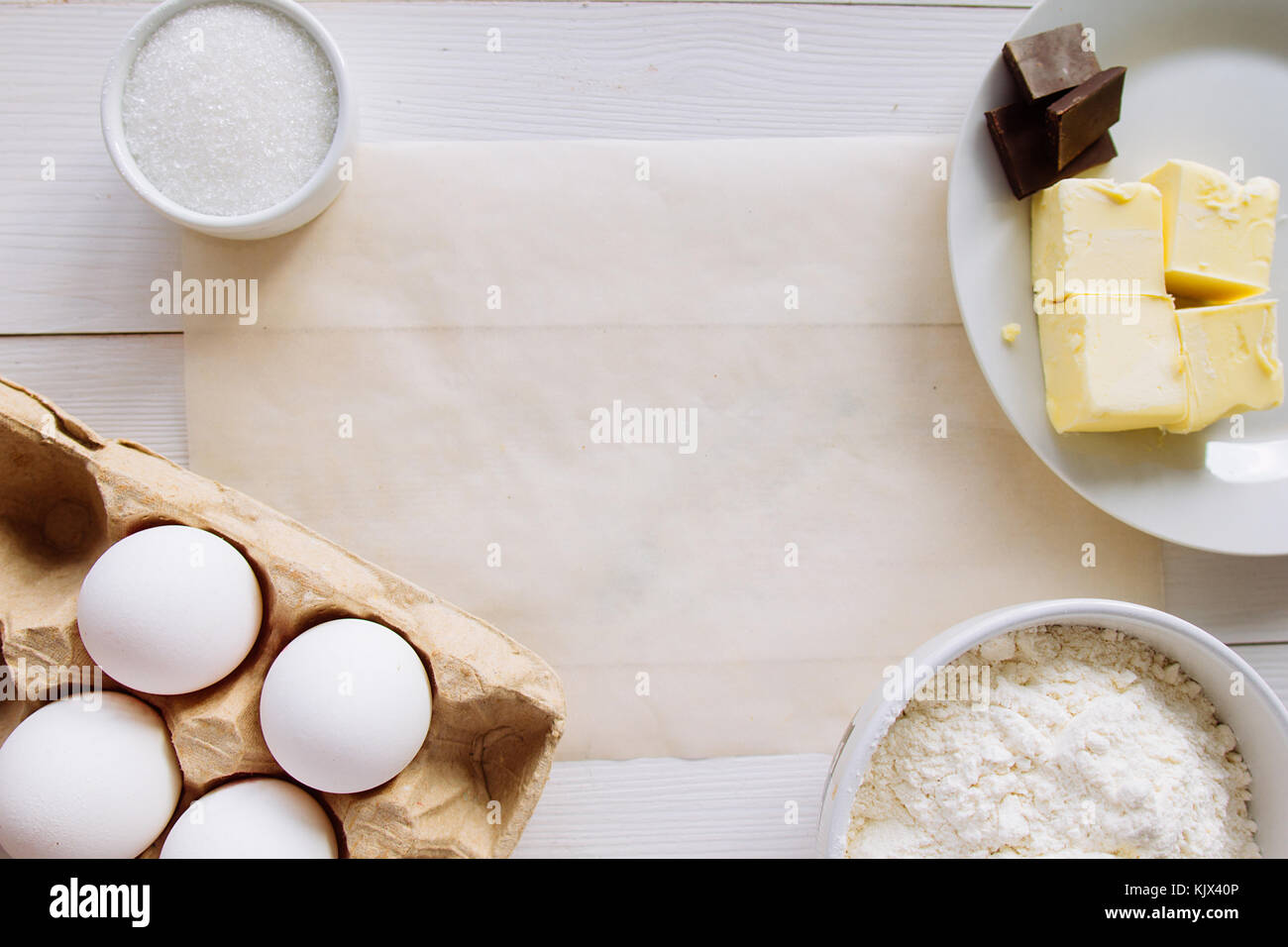 Eggs, butter, flour and cooking paper copy space selective focus Stock Photo