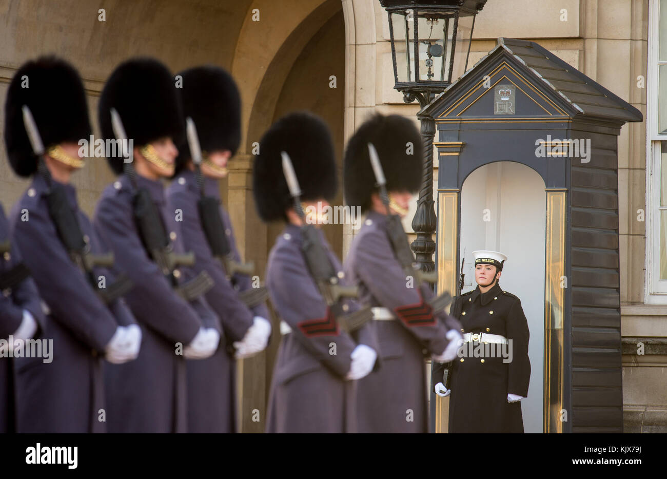 Able seaman Laura Suttle takes her position in a sentry box, as sailors from the Royal Navy perform the Changing of the Guard ceremony at Buckingham Palace, London, for the first time in its 357-year history. Stock Photo