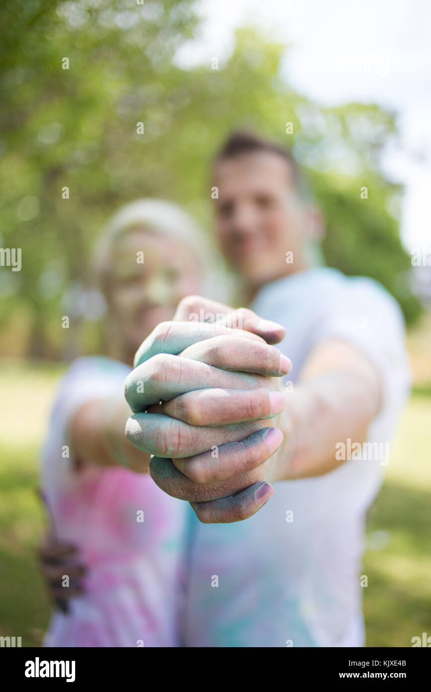 Powder Paint Playing Young funky couple playing with colourful water paint powder on the ...