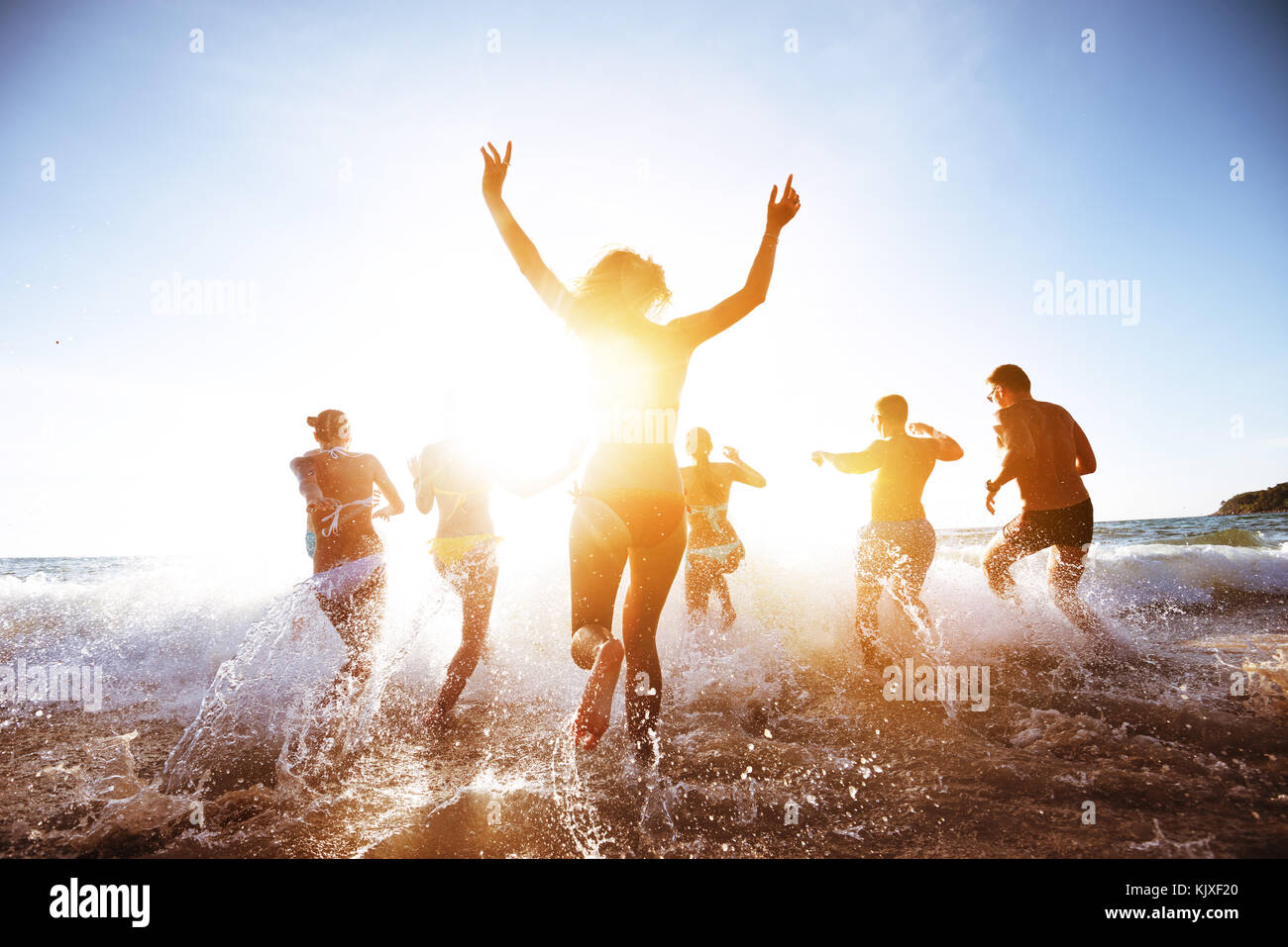 Beautiful people sunset sea beach Stock Photo