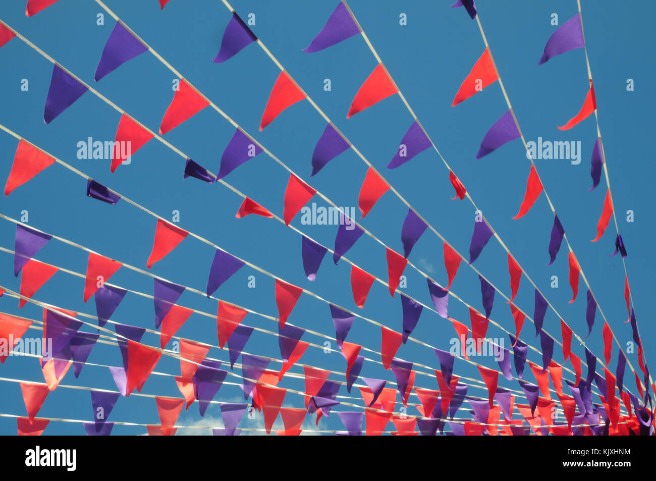 Summer bunting flags against a blue sky Stock Photo - Alamy
