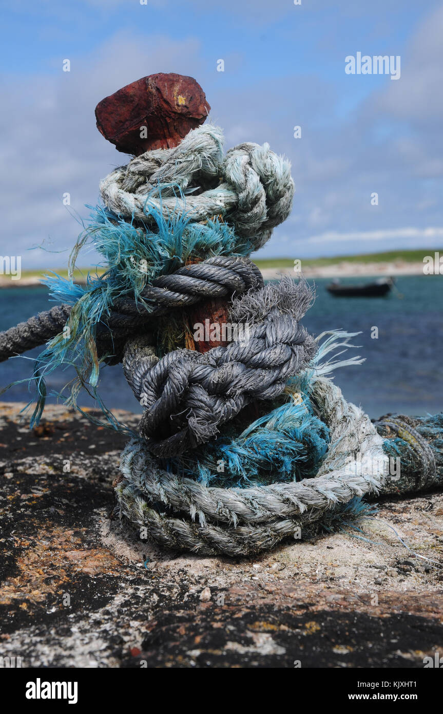 Irish Ropes Knotted rope on an iron stanchion on a harbour with traditional Irish ...