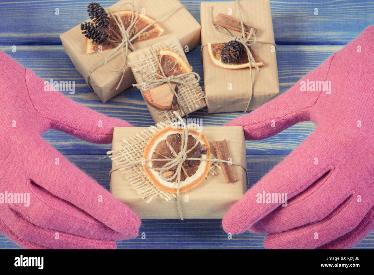 Handsel Vintage photo, Hands of woman in pink woolen gloves and decorated gifts ...
