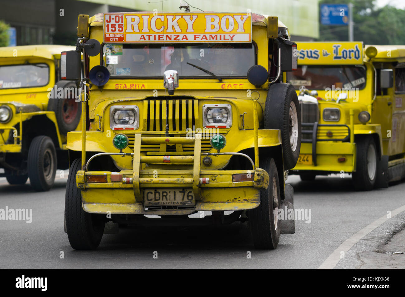 A yellow Public Utility Jeepney Vehicle being driven in Olongapo City,Bataan,Philippines Stock Photo