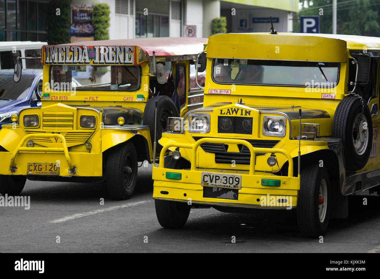 A yellow Public Utility Jeepney Vehicle being driven in Olongapo City