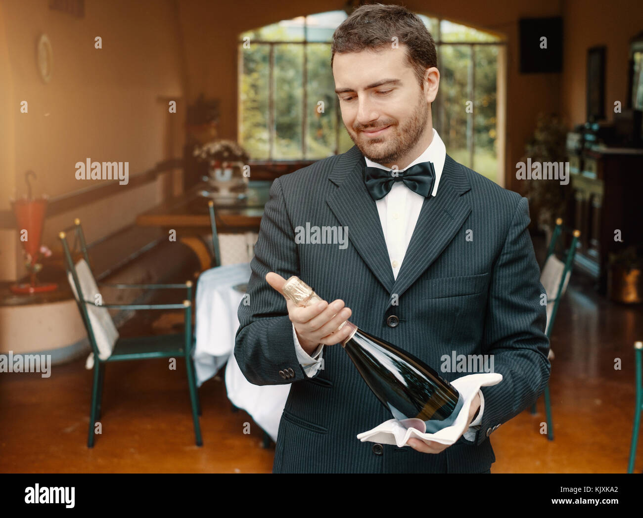 Waiter holding tray bottle wine hi-res stock photography and images - Alamy