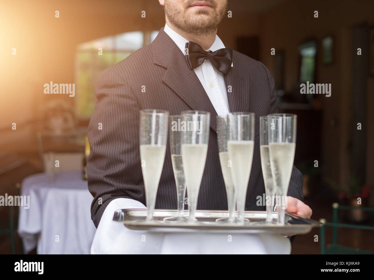 Portrait of waiter holding glasses of champagne Stock Photo