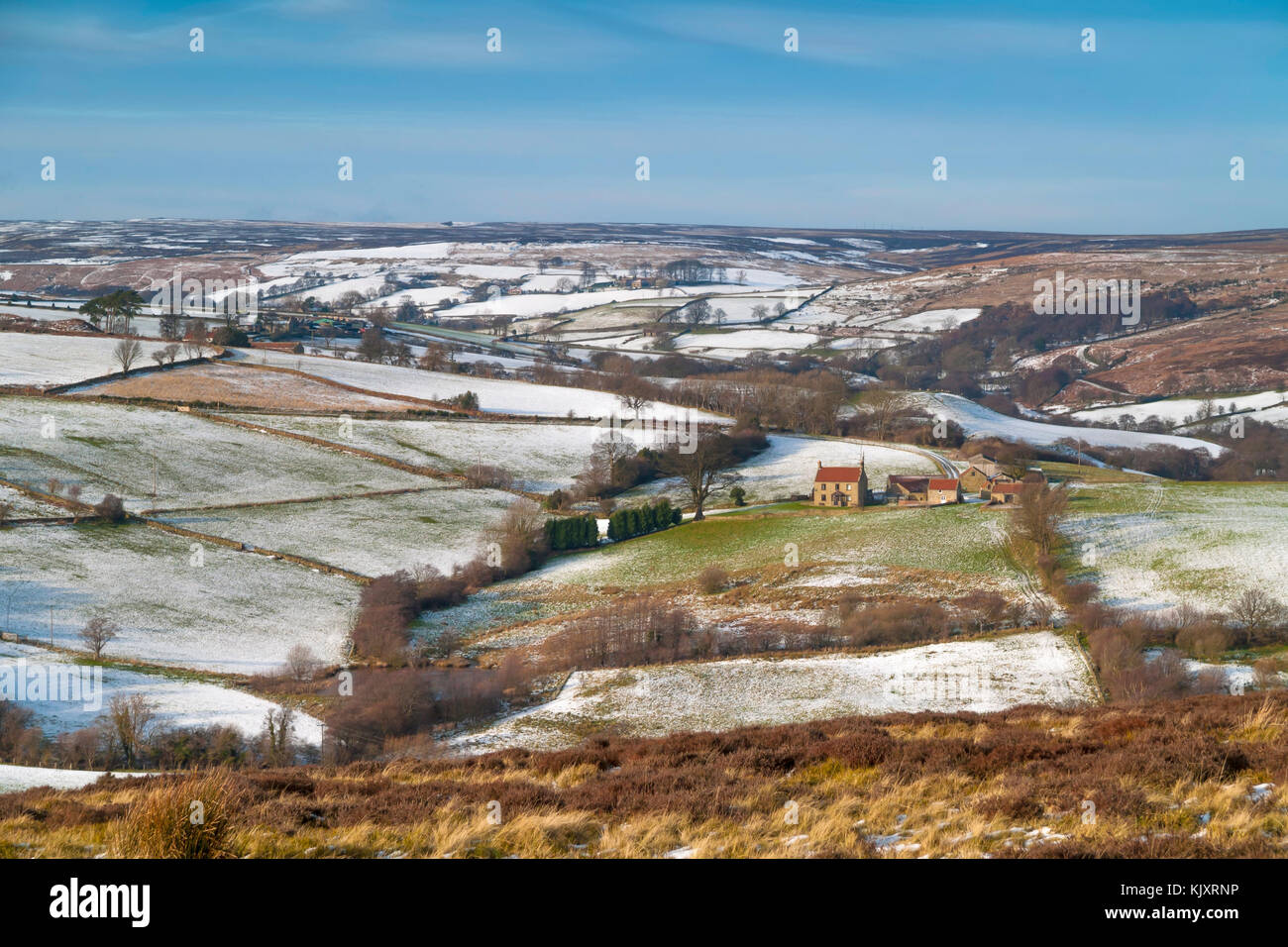 Distant view of a farm near Castleton North Yorkshire UK in snowy