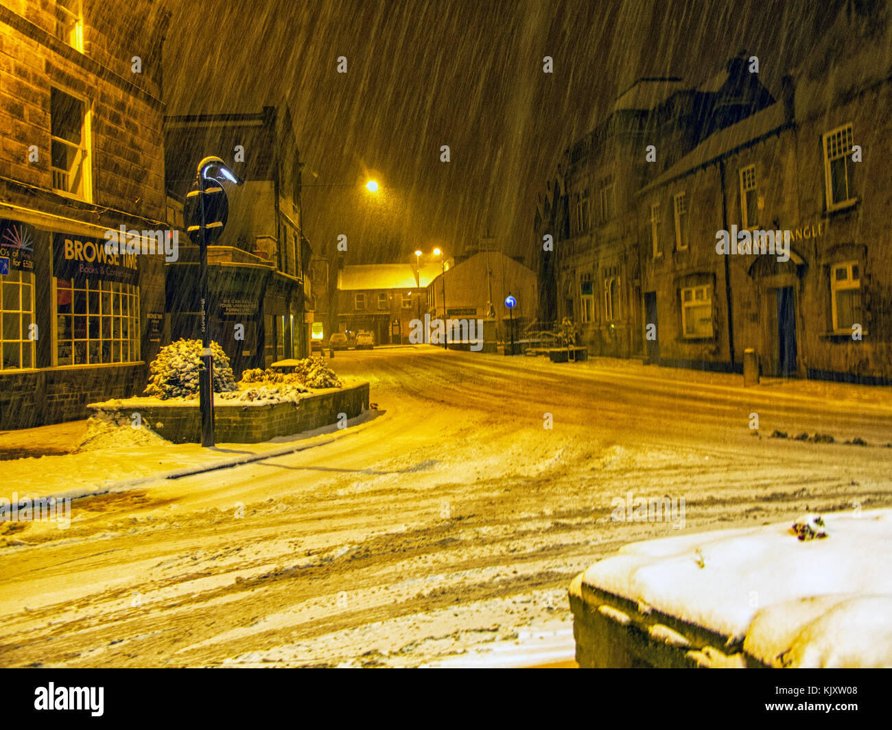 Otley in West Yorkshire showing the road junction of Bridge street, Clapgate and Courthouse street with snow falling on a cold February night. Stock Photo