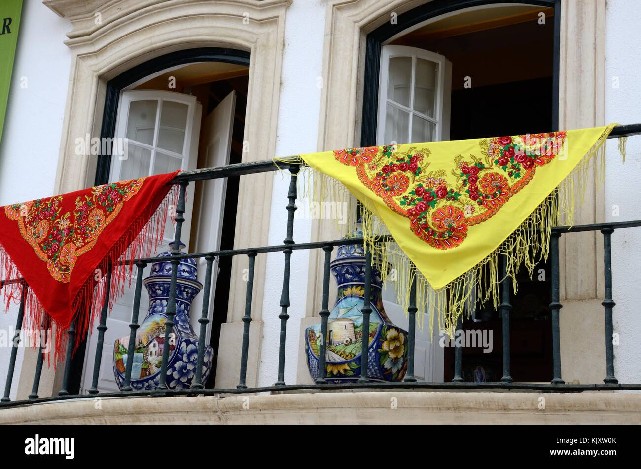 Colourful Portuguese shawls and pottery on a balcony Alcobaca Portugal Stock Photo
