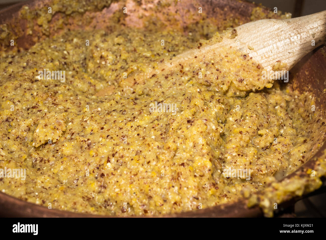 Polenta cooking in the traditional cauldron. Authentic Italian recipe. Stock Photo