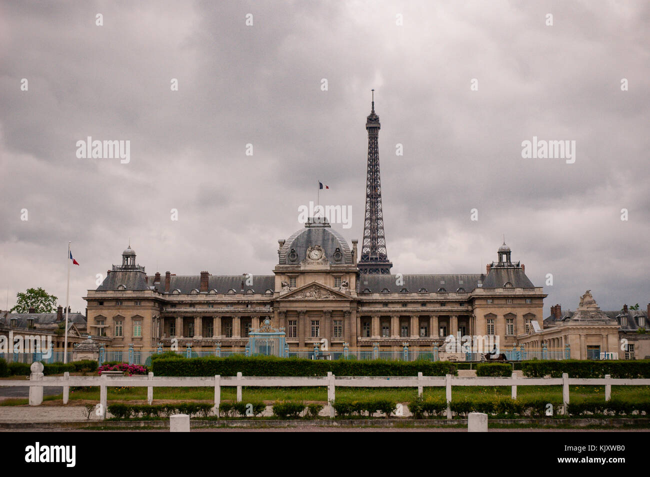 Front facade of the Historical building of Paris Military School (École Militaire) with the Eiffel tower in the background. Academy, Paris, France. Stock Photo