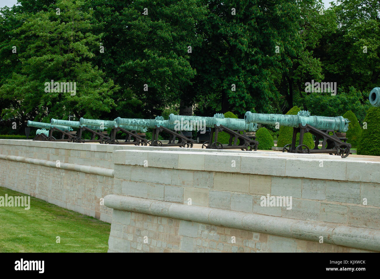 Row of historic ancient cannons forming the Triumphal Battery of the Hôtel Les Invalides museum in Paris France Stock Photo