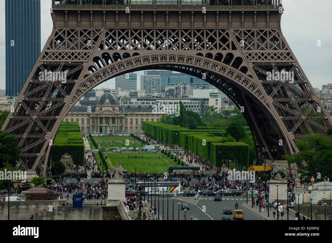 Busy day with tourists gathering around the Eiffel tower in Pairs