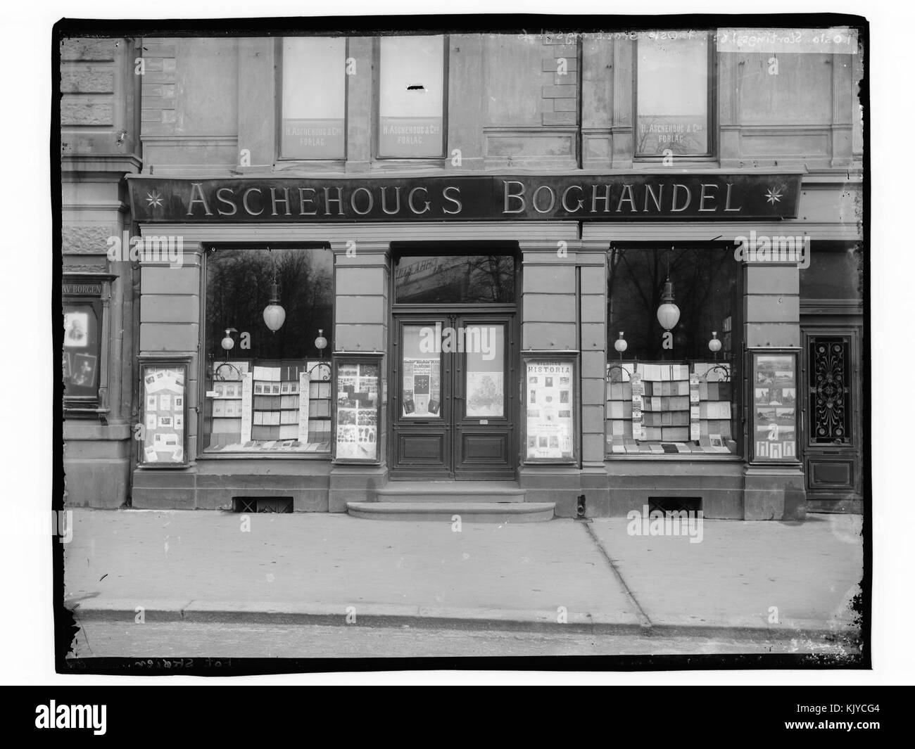 A photograph of *Aschehougs Bookstore* on *Stortingsgt. 6* in *Oslo*, Norway, featuring the bookstore’s facade and display window. The image captures the architectural style of this historic building in the heart of Oslo's city center. Stock Photo