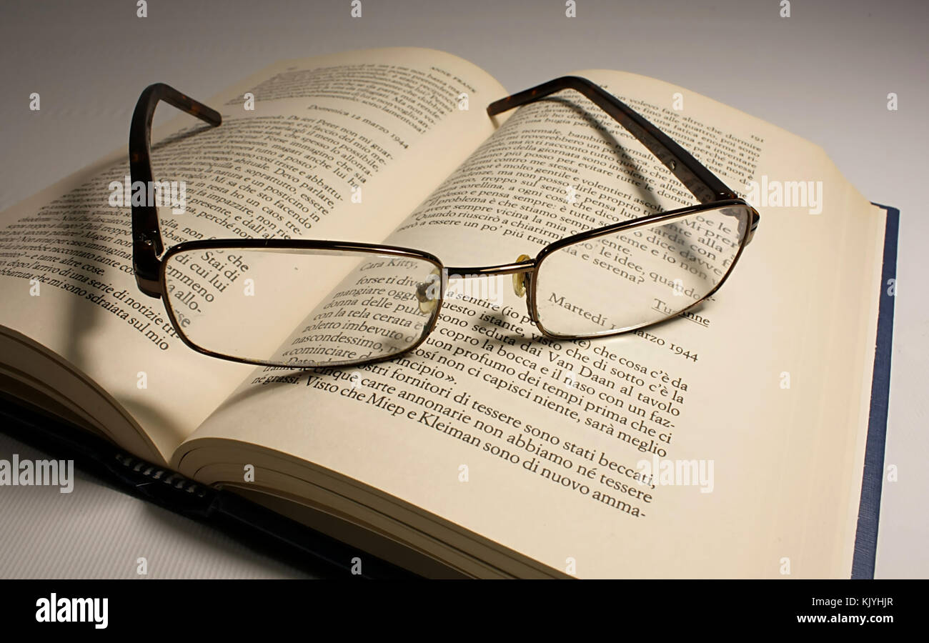 open book and reading glasses Stock Photo
