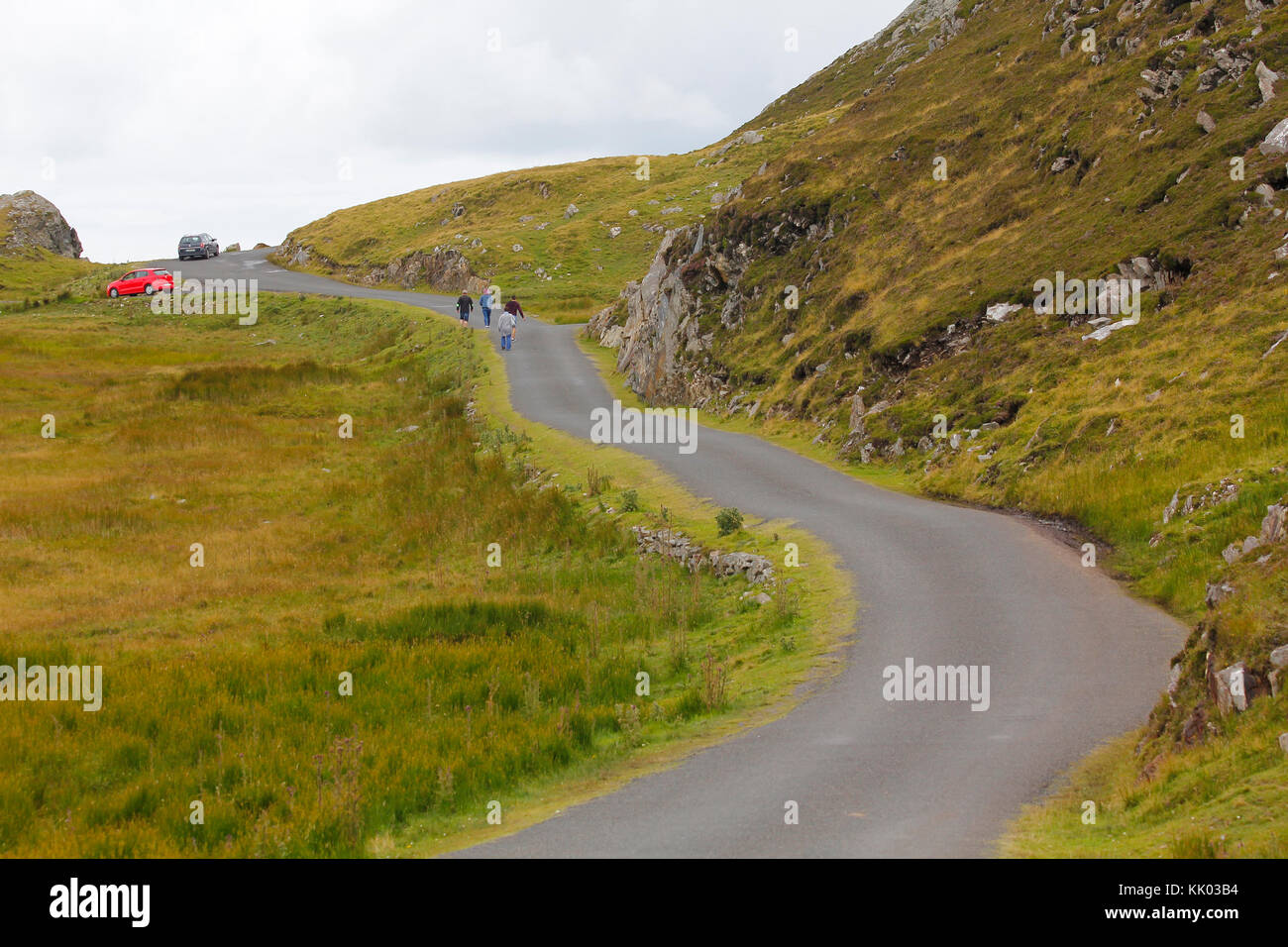Green road in Ireland, with people walking and cars Stock Photo Alamy
