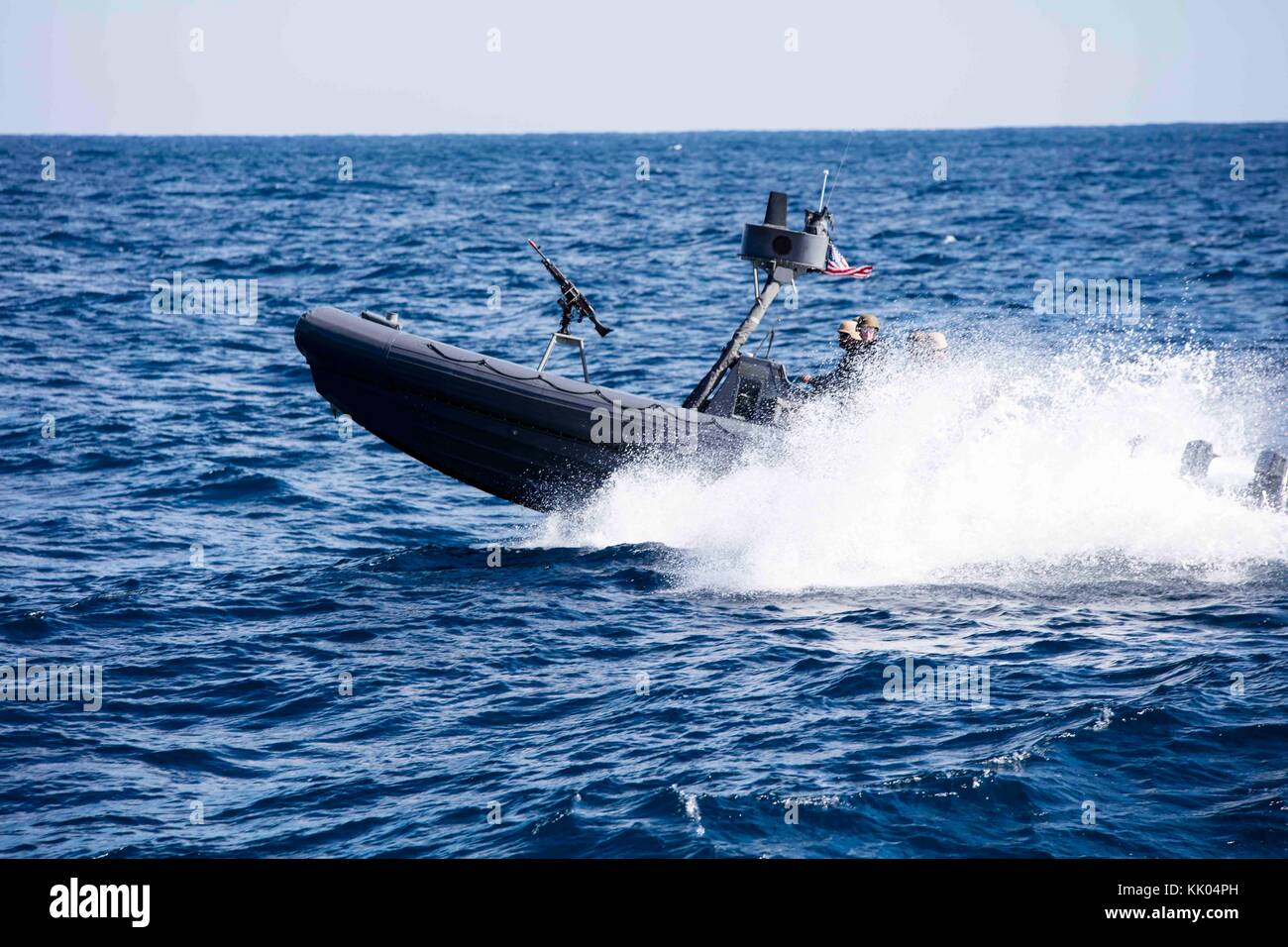 Two 11-meter Navy Special Warfare Rigid Hull Inflatable Boats transit to the amphibious transport Stock Photo