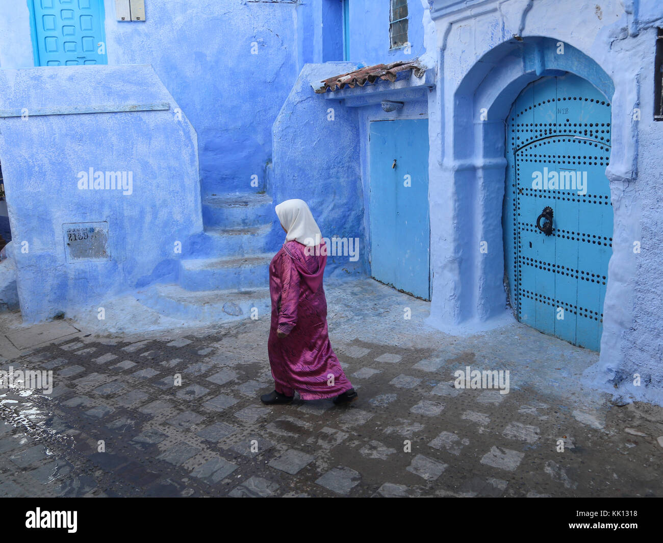 Woman walking in Chefchaouen, Morocco Stock Photo