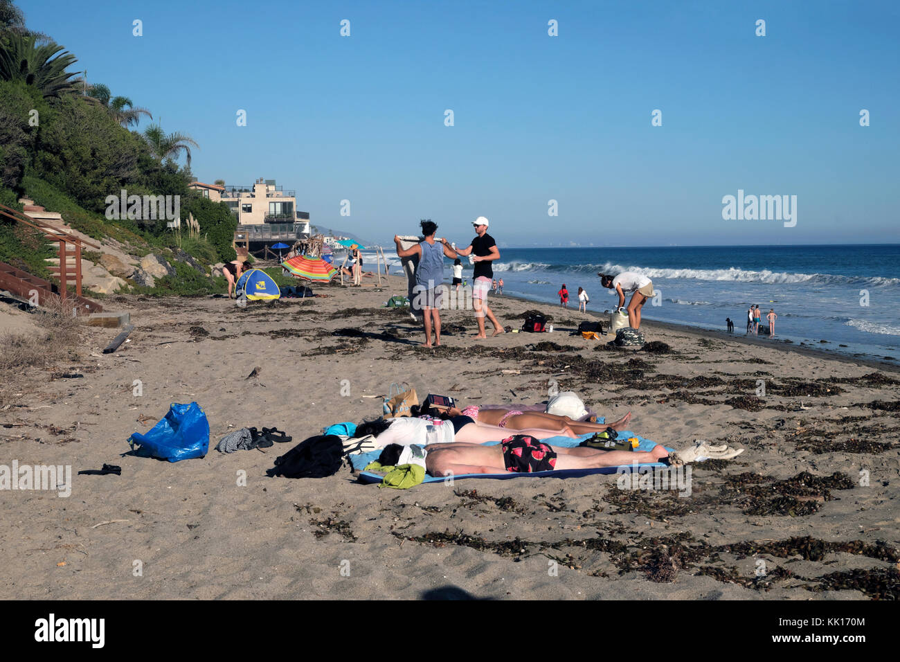 Young people relaxing in October sunshine on Escondido Beach near Los Angeles, California, USA  KATHY DEWITT Stock Photo
