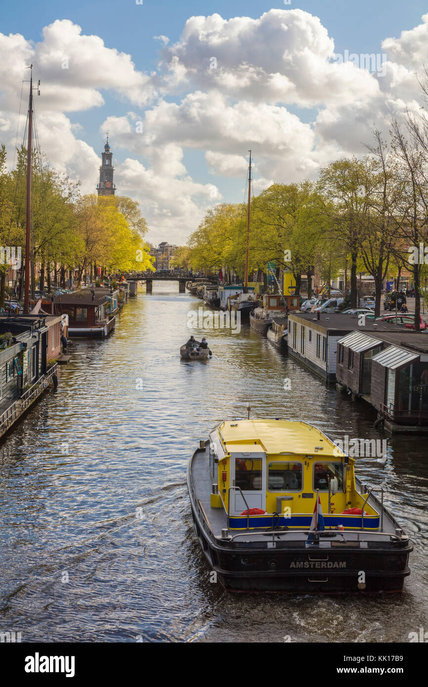 View down the canal with Westerkirk Church in the background, Central Amsterdam, The Netherlands Stock Photo