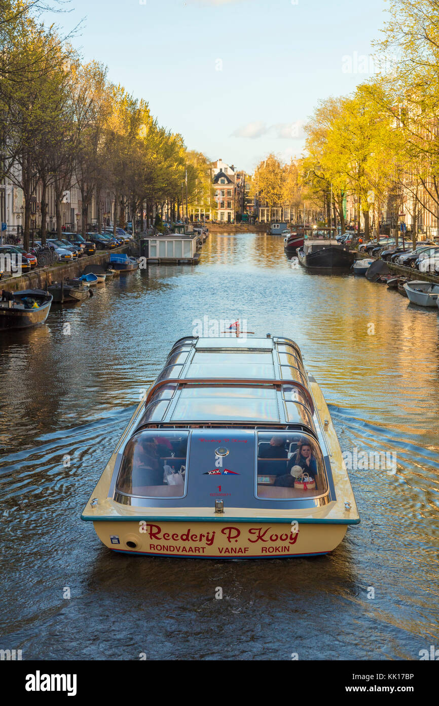 Pleasure boat on canal, central Amsterdam, The Netherlands Stock Photo