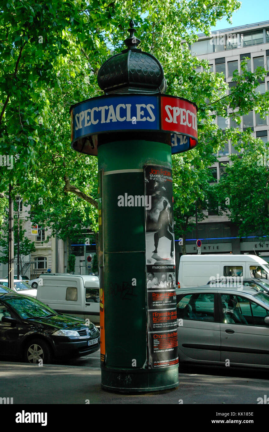 Cylindrical advertising pillar with posters on the street of Paris Stock Photo