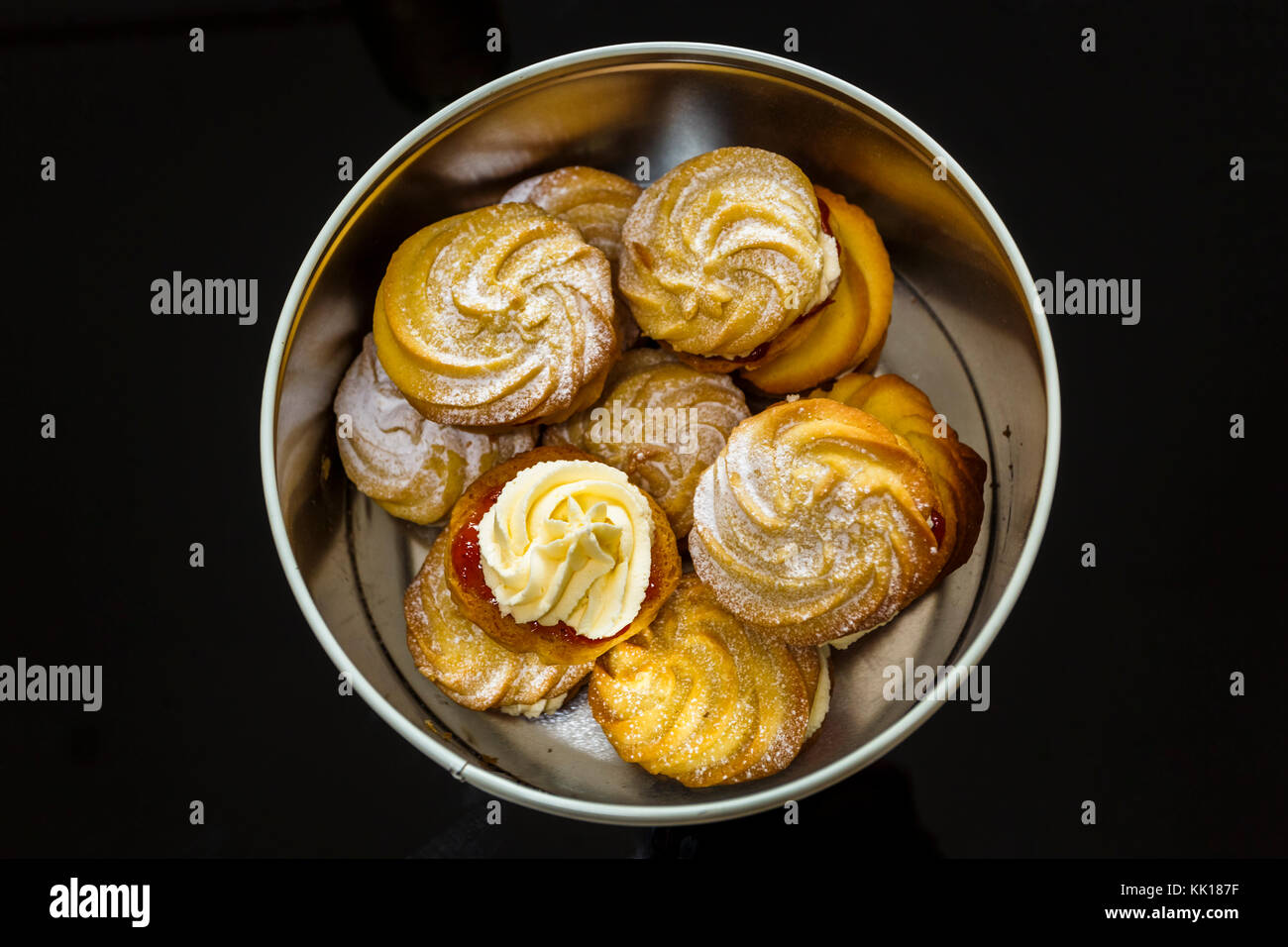 Home baking & cookery: Traditional home-baked Viennese whirls, made to the Mary Berry recipe used on The Great British Bake Off, in a round cake tin Stock Photo