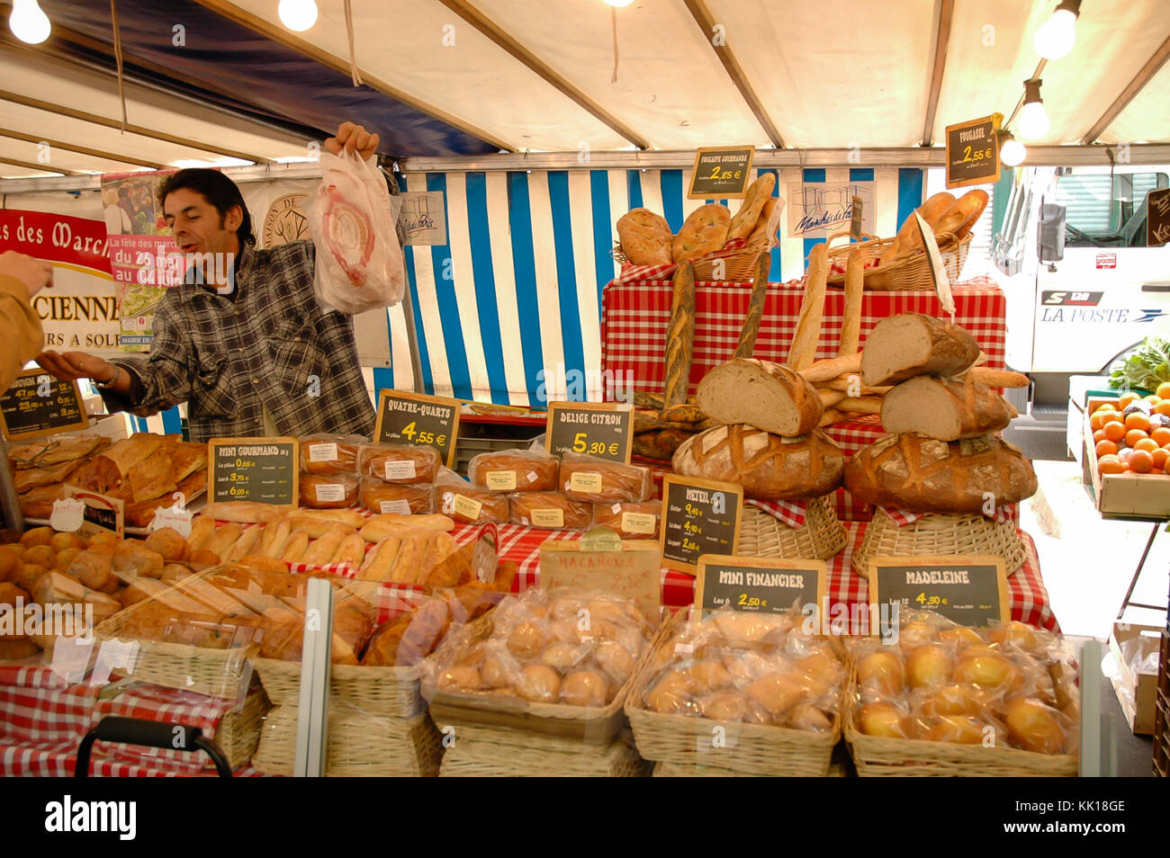 Open air market bakery stall in Paris selling bread baguettes cakes and