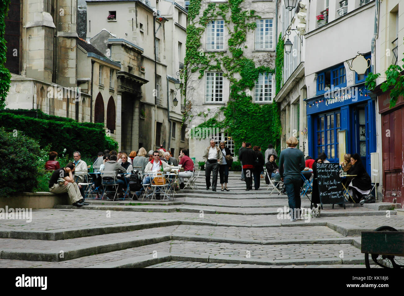 Tourists and locals relaxing in a quiet coffee shop in Paris surrounded